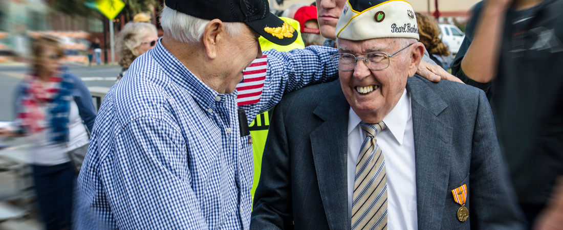 photo of two senior World War II veterans greeting each other
